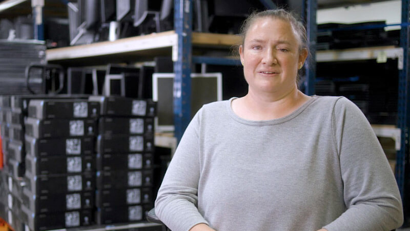 Woman sitting in front of computers